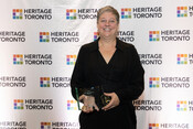 Heidi Reitmaier poses with Public History Award trophy for Derailed: The History of Black Railway Porters in Canada, Heritage Toronto Awards, October 17, 2022. Image by Ashley Duffus.