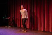 Performer Noah Spitzer on stage at the Whoopee Cushion Monologue Slam event, December 3, 2023.