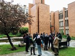 Group of people stand in the courtyard of Massey College, 2019.