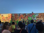 Tour participants examine a mural in Reggae Lane on the Eglinton West: Little Jamaica tour. Toronto, Ontario, August 08, 2019. Image by Heritage Toronto