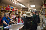 Tour leader showing abacus to tour group, Chinatown West, July 21, 2019. Image by Ali Mosleh.
