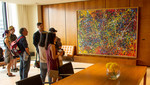 Group of people examine the Riopelle painting on the 54th Floor of the Toronto-Dominion Centre. 