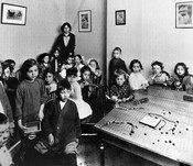 Children's hour with Elizabeth Neufeld, the first Central Neighbourhood House, Gerrard Street, Toronto, winter 1913. Image courtesy of the City of Toronto Archives.