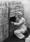 Woman stamping boxes at the General Engineering Company (GECO) munitions factory, Scarborough, ON. Image: Archives Ontario