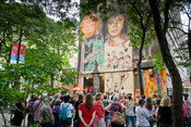 Tour group views mural on building at 423 Yonge Street, July 4, 2019. Image by Herman Custodio.