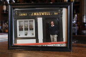 Framed photograph of John Maxwell on counter at Allen's restaurant, November 18, 2022. 